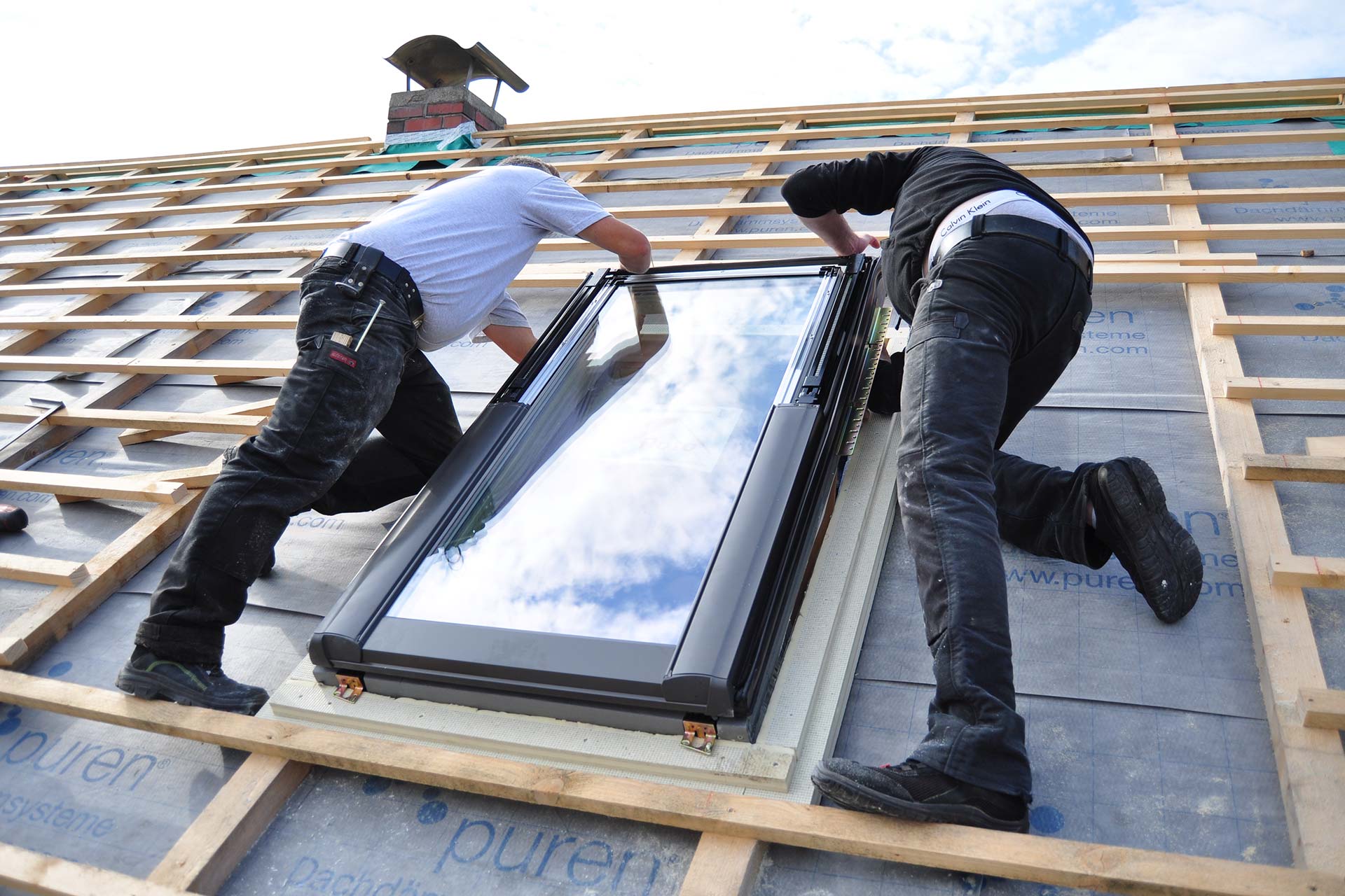two-men-assembling-a-roof-skylight-window-2022-09-23-16-16-27-utc
